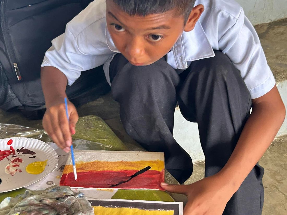 Negros students painting in gymnasium